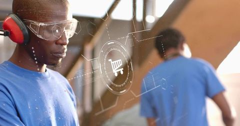 Carpenter wearing safety gear working with plywood while digital shopping cart icon overlay