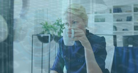 Thoughtful woman enjoying coffee amidst digital overlay