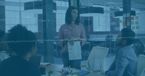 Confident Woman Leading Business Presentation to Team