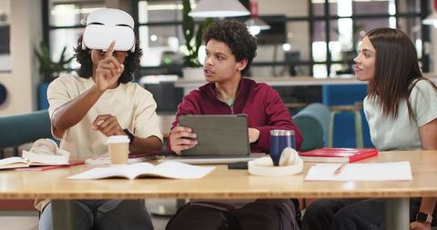 African American coworkers collaborating while exploring virtual reality in modern coworking space