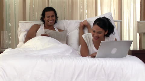 Couple Enjoying Leisure Time in Cozy Bedroom