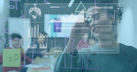 Woman writing on glass board with digital analytics dashboard during team workshop