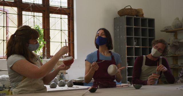 Three People Working on Pottery in Art Studio - Download Free Stock Images Pikwizard.com