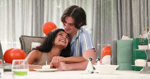 Happy Couple Celebrating Birthday with Candlelit Cupcake