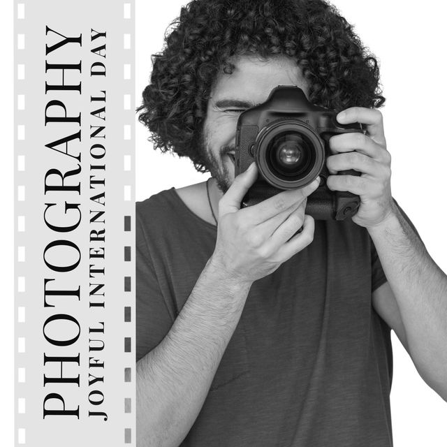This image features a young male photographer with curly hair joyfully using a digital camera, set against a black and white theme. The text on a film reel commemorates International Photography Day. Ideal for use in campaigns promoting photography events, blog posts about photography hobbies, articles on photo techniques, or social media posts celebrating photographers.