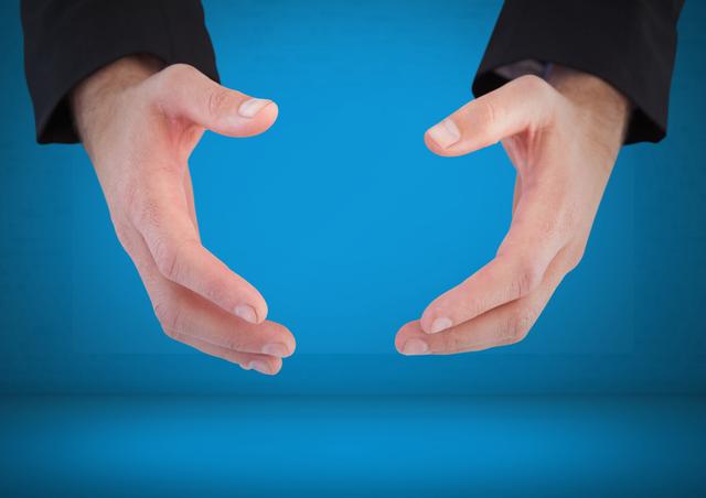Digital composite of Hands arched apart against blue background
