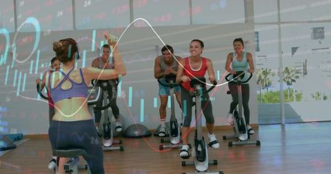 Leading spin class with trainer cueing group cycling workout and fitness data overlay