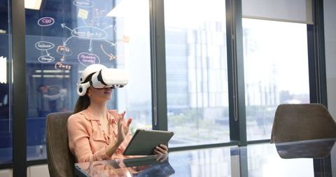 Businesswoman using VR headset in innovative tech office environment