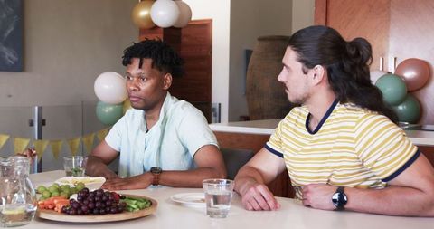 Friends bonding at home with healthy snacks and conversation