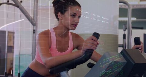 Woman pedaling on stationary bike monitoring fitness metrics with digital analytics overlay