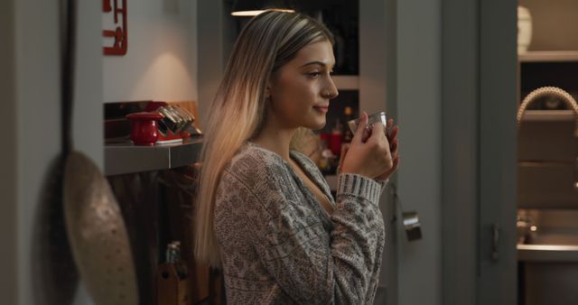 Relaxed Young Woman Enjoying Hot Drink in Cozy Kitchen - Download Free Stock Images Pikwizard.com