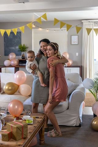 Family celebrating at home amidst gold and pink decor