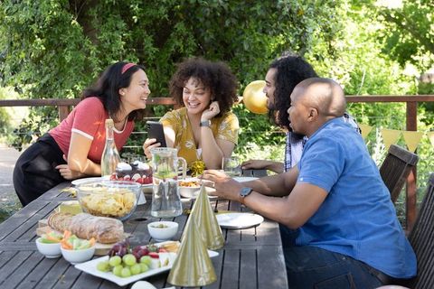 Diverse Friends Celebrating Outdoors with Snacks and Decorations