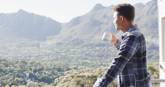 Young Man Enjoying Morning Coffee on Balcony with Mountain View - Download Free Stock Images Pikwizard.com