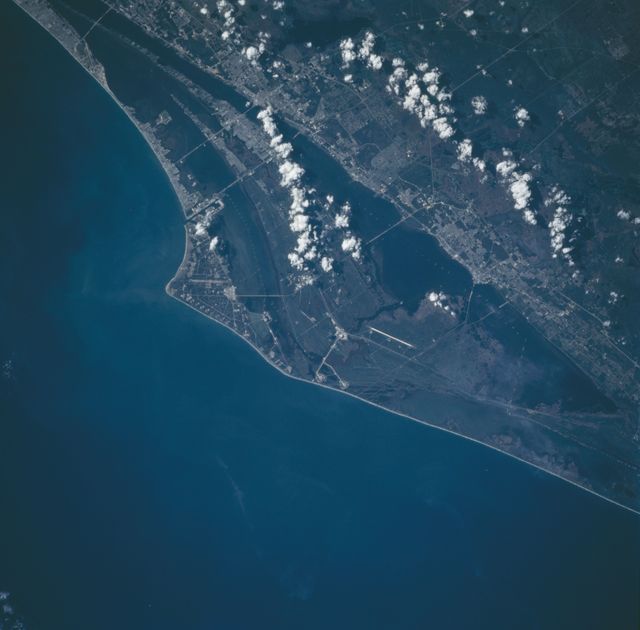 This nadir photograph of the Cape Canaveral area on Florida's eastern coast was taken by the STS-66 crew in November, 1994. The Space Shuttle Vehicle Assembly area and the runways used by the returning Shuttles can be seen near the center of this photograph as part of the John F. Kennedy Space Center (KSC). Launch Pads A and B as well as many other launch pads and a runway can be seen on Cape Canaveral. Cape Canaveral is located to the east of KSC. South of the launch area is Port Canaveral and Cocoa Beach on the Atlantic coast with the towns of Cocoa, Merrit Island and Titusville situated along the Intercoastal Waterway.