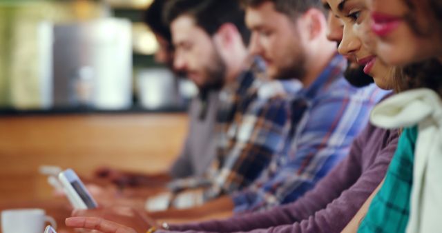 Group of People Sitting in a Row Working on Smartphones, Focused and Engaged - Download Free Stock Images Pikwizard.com