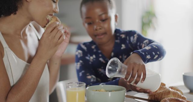 Mother and Daughter Eating Breakfast Together - Download Free Stock Images Pikwizard.com