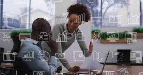 Woman Guiding Male Coworker at Laptop, Collaborating on Analytics, Charts and Strategy