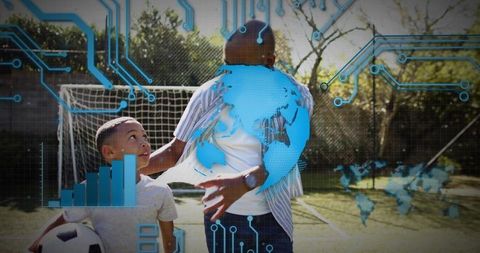 Father guiding son on soccer field with augmented reality globe overlay showing global coaching