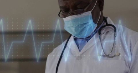 Doctor analyzing digital ecg in medical clinic with technological overlay