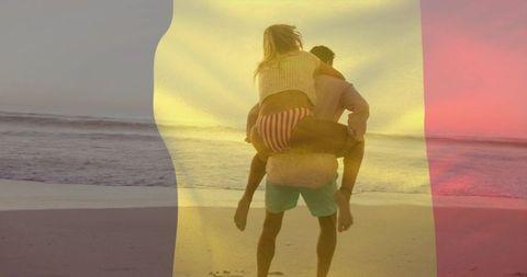 Couple walking on beach at sunset with piggyback ride and warm tricolor light overlay