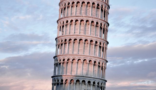 Perfect for travel and tourism websites or blogs, this image captures the vibrant colors of the sky providing a beautiful backdrop to the iconic Leaning Tower of Pisa. It is ideal for educational materials, travel brochures, or any media needing an image of famous historical landmarks.