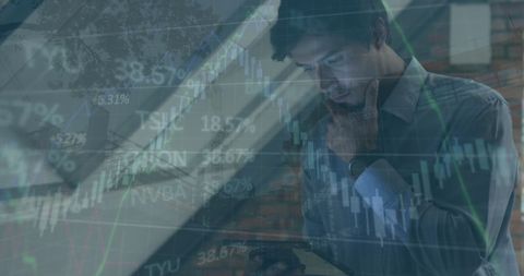Businessman analyzing financial data with digital tablet overlay