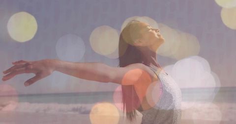 Woman Embracing Freedom at Beach with Bokeh Overlay