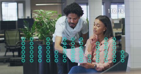 Business Colleagues Analyzing Virtual Financial Data in Office