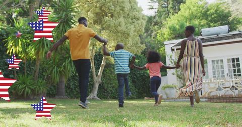Joyful African American Family Celebrating Independence Day Outdoors