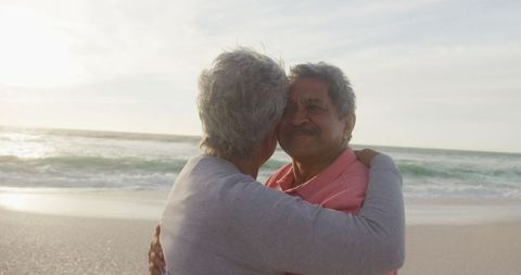 Joyful Senior Couple Embracing On Scenic Beach at Sunset - Download Free Stock Images Pikwizard.com