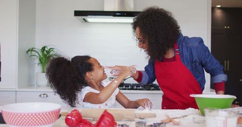 Mother and Daughter Baking and Having Fun in Kitchen