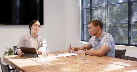 Business Colleagues Discussing Strategies in Modern Office Setting