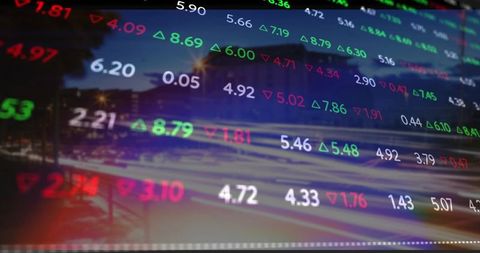 Digital stock market data overlaying night cityscape