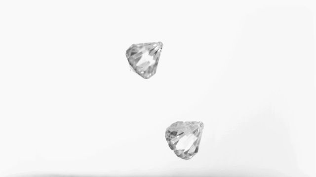 Diamonds appear to float gracefully against a plain white backdrop, enhanced by elegant slow motion effect, emphasizing their brilliance and luxury. Includes concepts of high-end jewelry or luxury ads. Ideal for use in marketing upscale products, jewelry collections, or luxury branding initiatives.