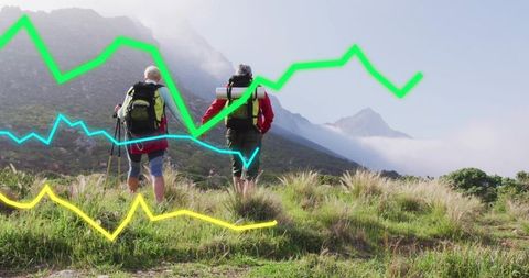Senior couple hiking misty mountain ridge with colorful analytics graph overlay