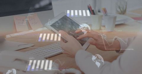 Businesswoman using tablet at desk with digital data overlays and desktop keyboard