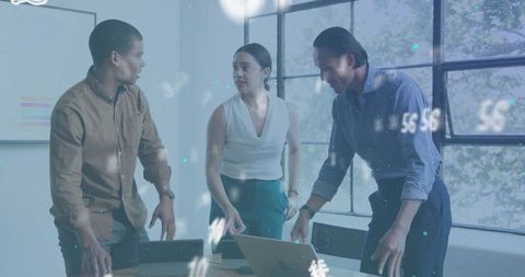 Collaborating team reviewing laptop analytics in modern daylight office meeting room