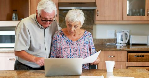 Senior Couple Reviewing Finances Together in Kitchen - Download Free Stock Images Pikwizard.com