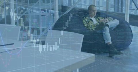 Young professional checking stock charts on smartphone in modern coworking lounge