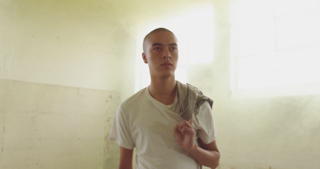 Contemplative Young Man in Sunlit Room with Blank Space - Download Free Stock Images Pikwizard.com