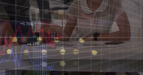 Businesspeople Analyzing Stock Market Data in Modern Office