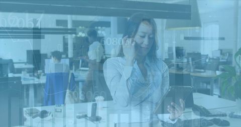 Diverse Business Team Using Tablet with Financial Data Overlay in Modern Office - Download Free Stock Images Pikwizard.com