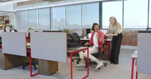 Collaboration and fun: colleagues in modern office setting