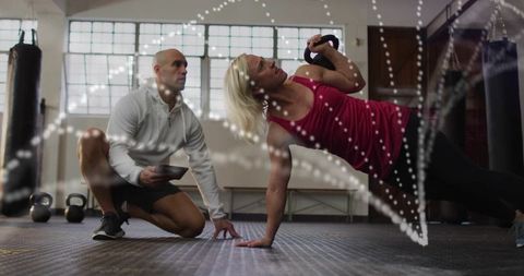 Fitness Training: Woman Doing Side Plank with Kettlebell