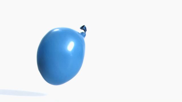 This close-up of a blue water balloon rebounding in super slow motion captures a dynamic and playful moment. It is ideal for advertisements, educational materials about physics, promotional content related to fun and entertainment, or artistic projects that emphasize motion and energy.