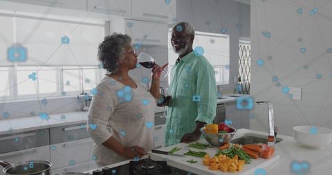 Senior Couple Enjoying Wine in Modern Kitchen with Digital Connectivity