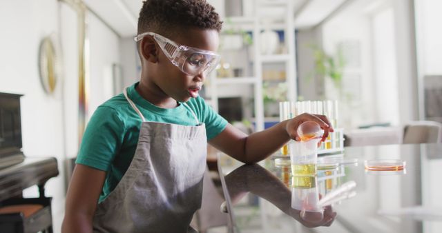 Image of african american boy doing experiments at home. Childhood, curiosity, education, spending free time at home concept.