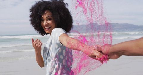 Joyful Couple Bonding at Beach with Color Celebration