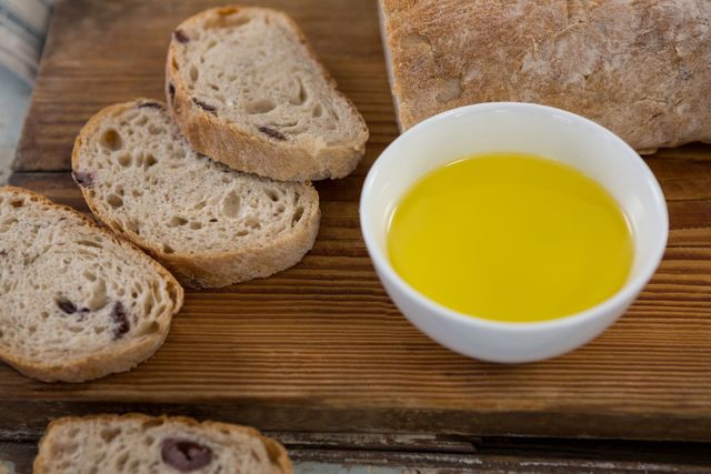 Slices of Artisan Bread with Olive Oil on Wooden Board - Download Free Stock Photos Pikwizard.com